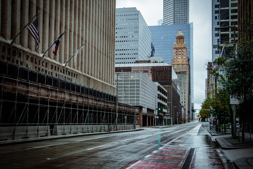 Miami Dolphins vs Houston Texans A rainy day view of Houston's downtown architecture featuring modern and historical buildings, empty street.