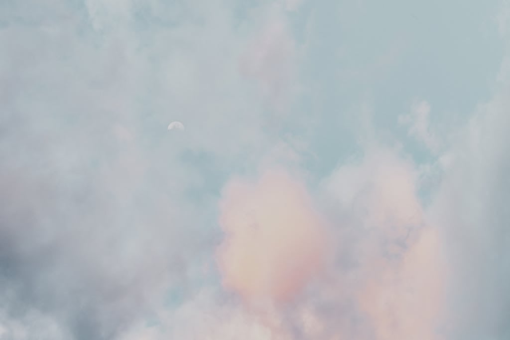  Mansutfer A serene scene of pastel clouds and a subtle moon in a calming sky, perfect for a peaceful backdrop.