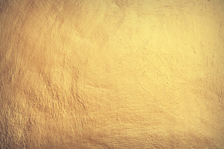 Hormita A vintage yellow stone wall texture perfect for wallpaper and design elements.