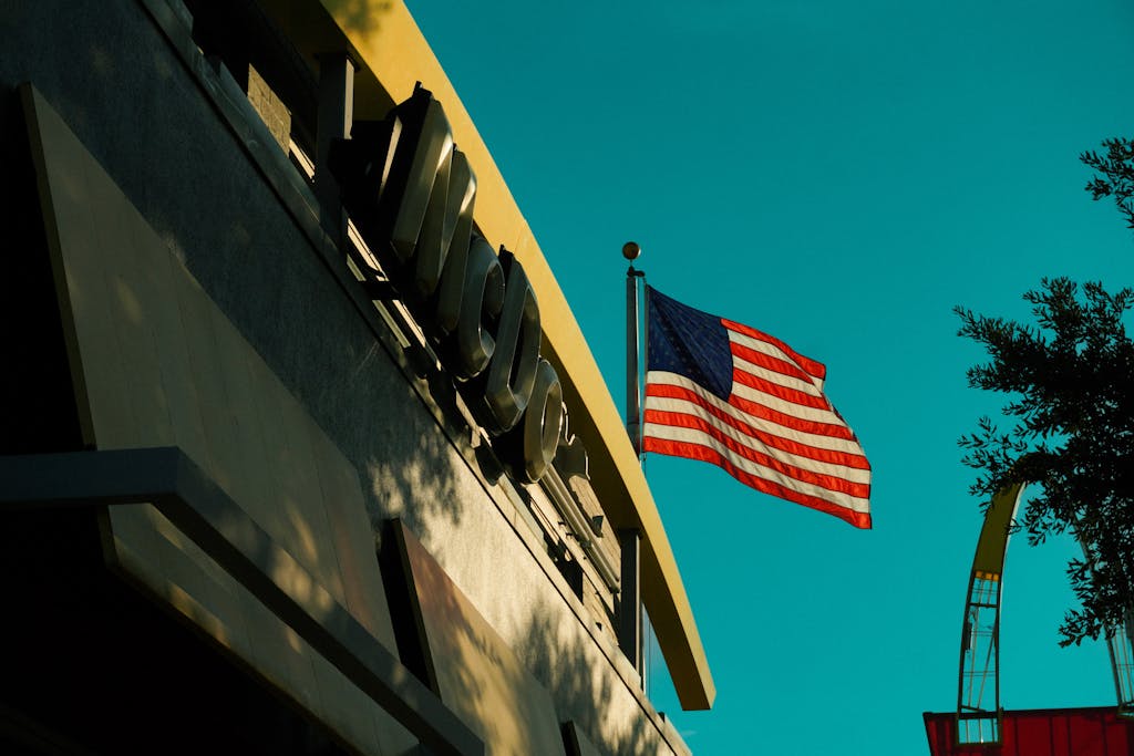 Miami Dolphins vs Houston Texans American flag waving beside a McDonald's sign in Houston, Texas during fall.