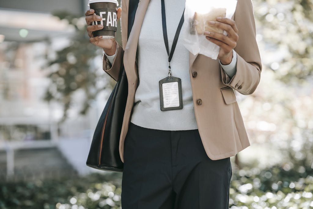 Entrepreneur Break Crop anonymous ethnic female entrepreneur with takeaway hot drink and bread walking to work