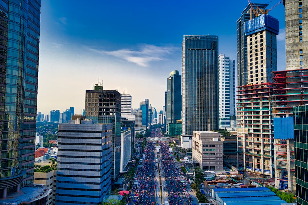 FintechAsia Stunning aerial view of Jakarta's modern skyline with bustling streets below.