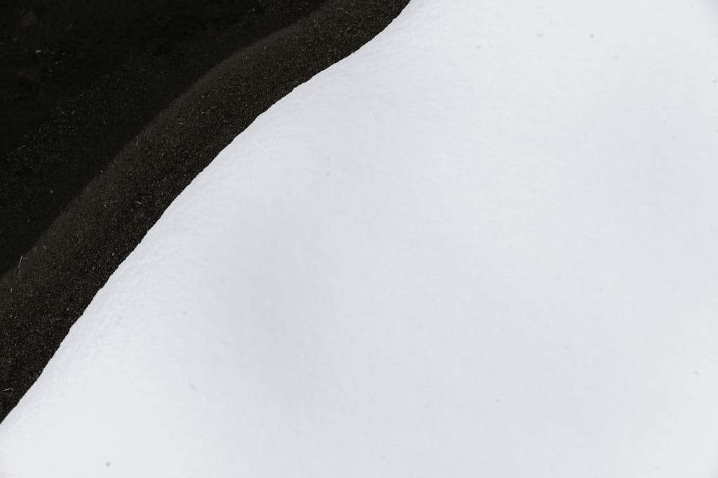 Hormita Top view of calm river flowing near bank covered with soft white snow