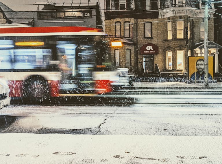 Nueraji vs Crosbie Prediction Urban winter scene in Toronto featuring a blurred bus in motion on a snowy night.