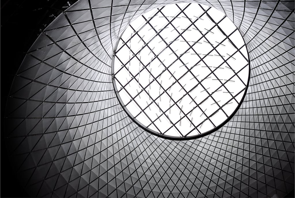 Sixmagazine Worm's eye view of a futuristic geometric skylight showcasing modern architecture.